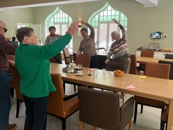 Der lange Esstisch im hellen Saal, an dem gemeinsam gegessen und gefeiert wird.